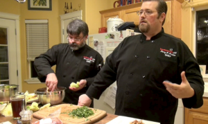 HAUTEMEALZ KITCHEN, PORTLAND, ORE. (November 6, 2013) As Chef Terry Ramsey (left) dishes us savory, crunchy lettuce rolls, Chef Perry Perkins (right) discusses issues that affect global food supply. Not a fan of GMOs, he talks about his experience on a humanitarian trip to Nigeria in his early 20's. "If I could have walked down the street and bought a bag of genetically modified soybeans to feed the people, I would have done it in a second. Having the political will to make tough decisions about population controls, changing policies that create endemic dependence on foreign aid, and overcoming tribal differences and power struggles that affect the distribution of food are not easy discussion to have or simple solutions to find, according to Perkins. (Photo by Kaley Perkins / Independent Journalist)